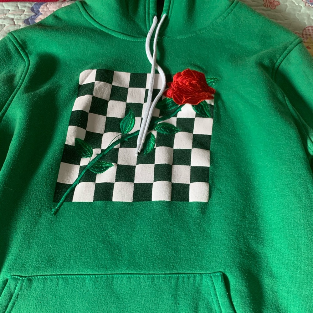 Green sweater with checkers and rose design